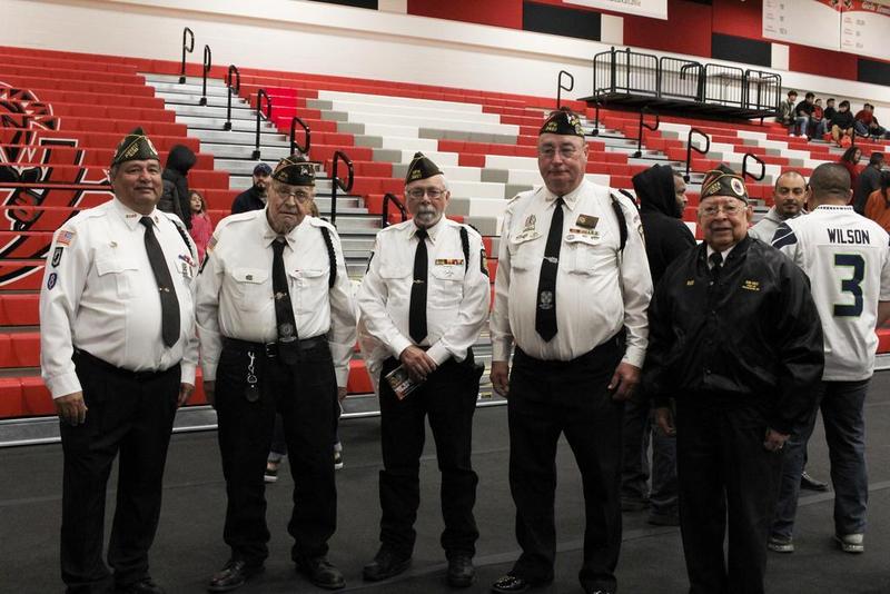 A small group of veterans standing together in their uniforms.