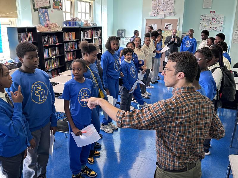 Students collaborating on building a paper tower
