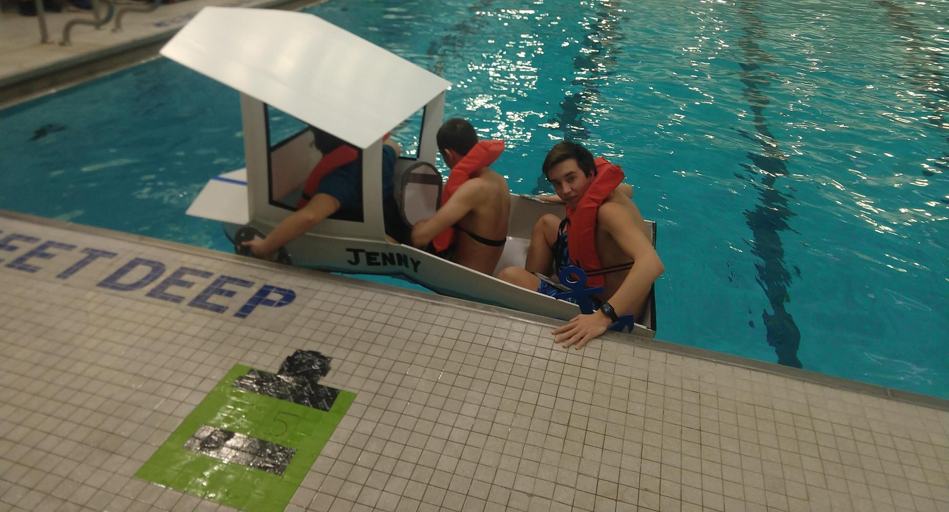 Students in boat in pool