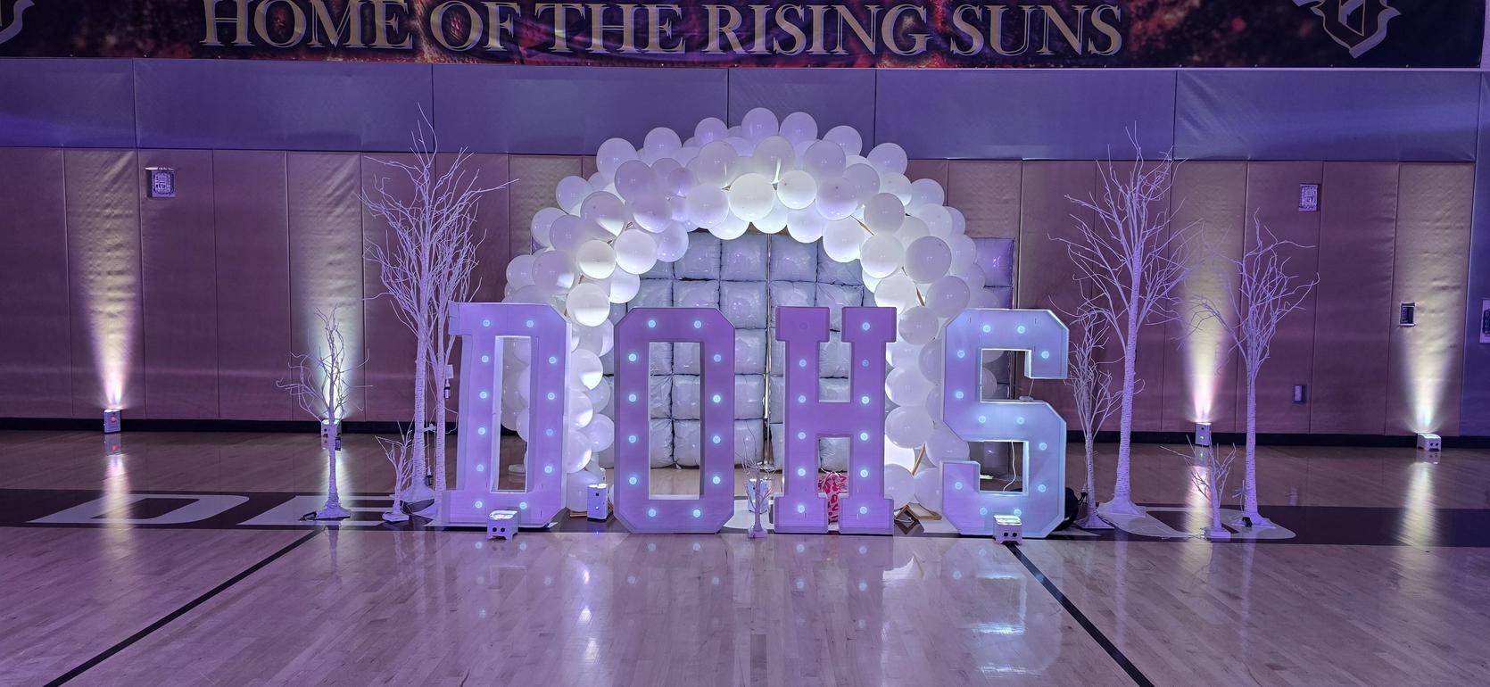 Decorative display with large letters spelling D.O.H.S. in a festive setting.