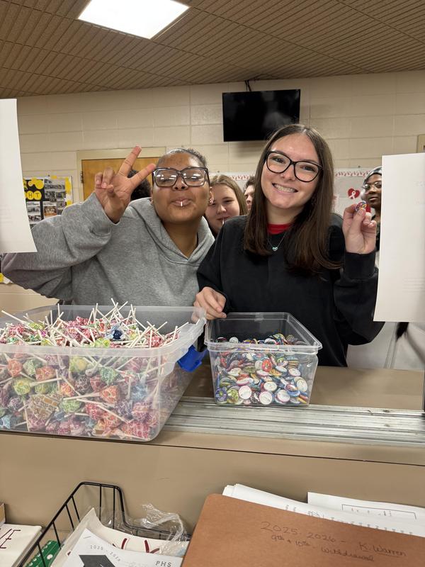 Two students getting dumdums