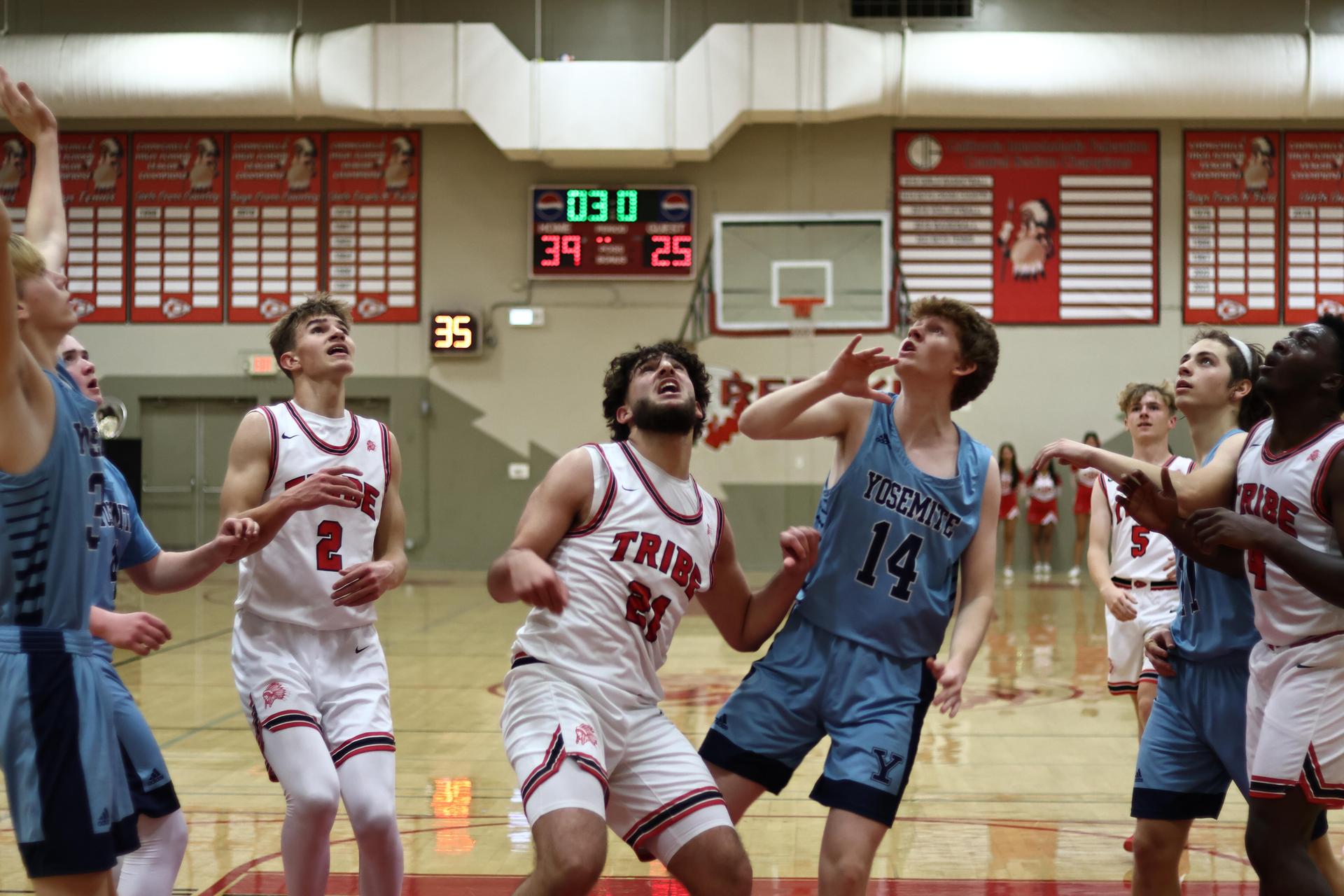 Varsity boys playing basketball against yosemite