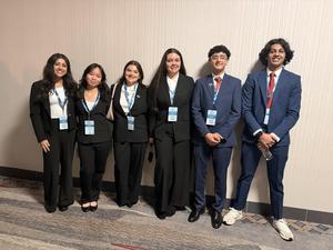 Smiling teens dressed in professional attire