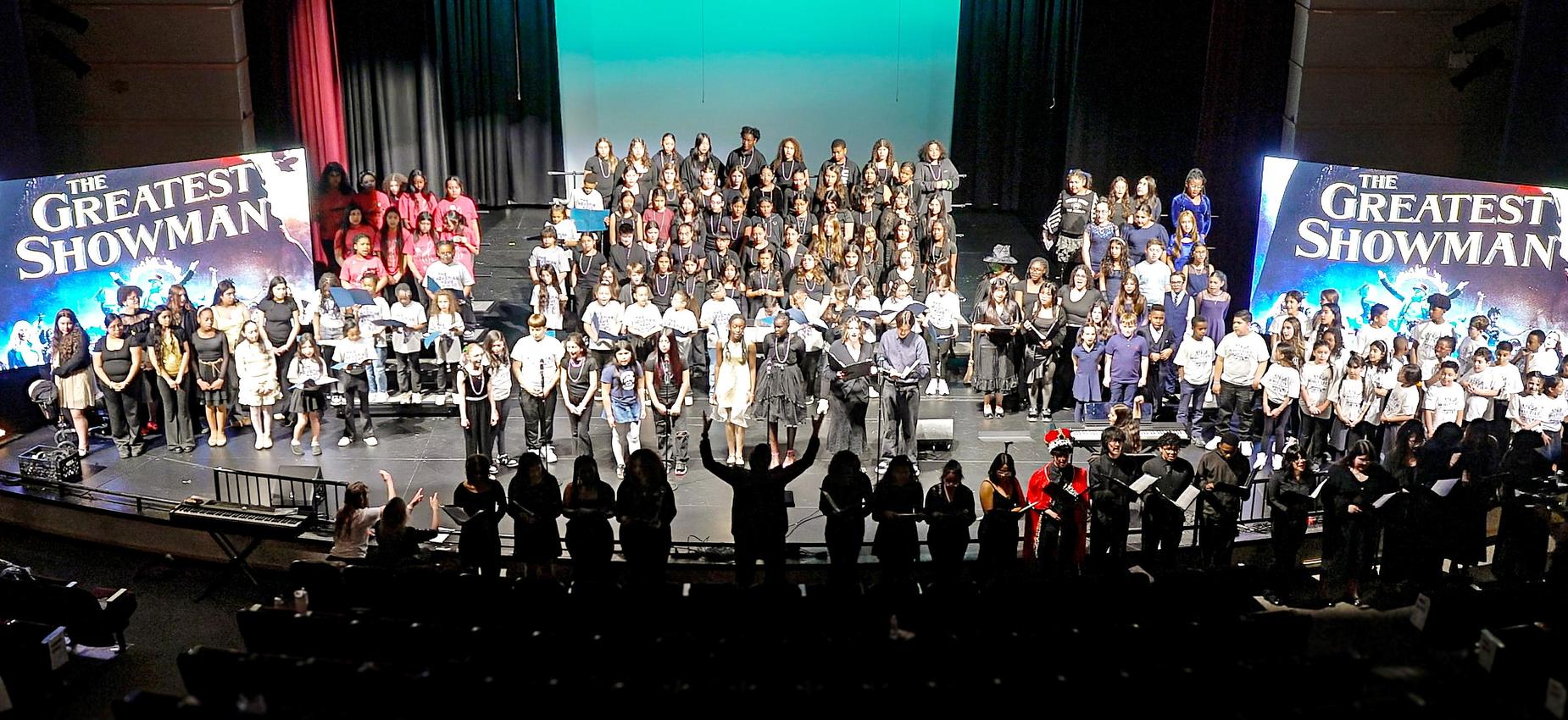 A large group of performers on stage at a musical event.