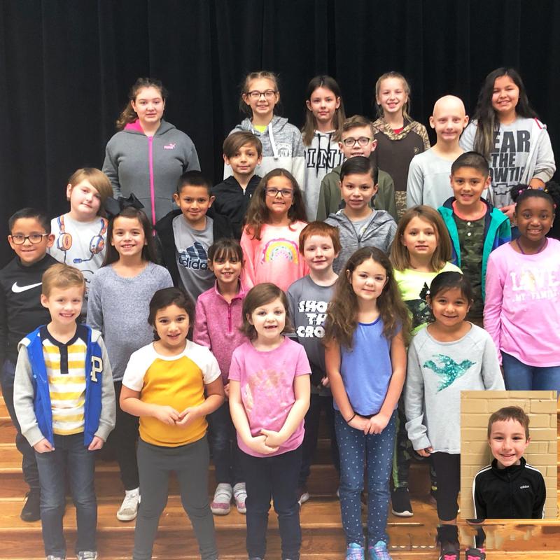 group of 25 students pose on stage steps