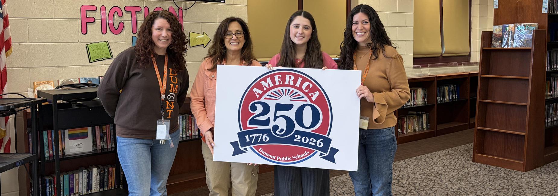 Student and teachers holding Rev250 logo