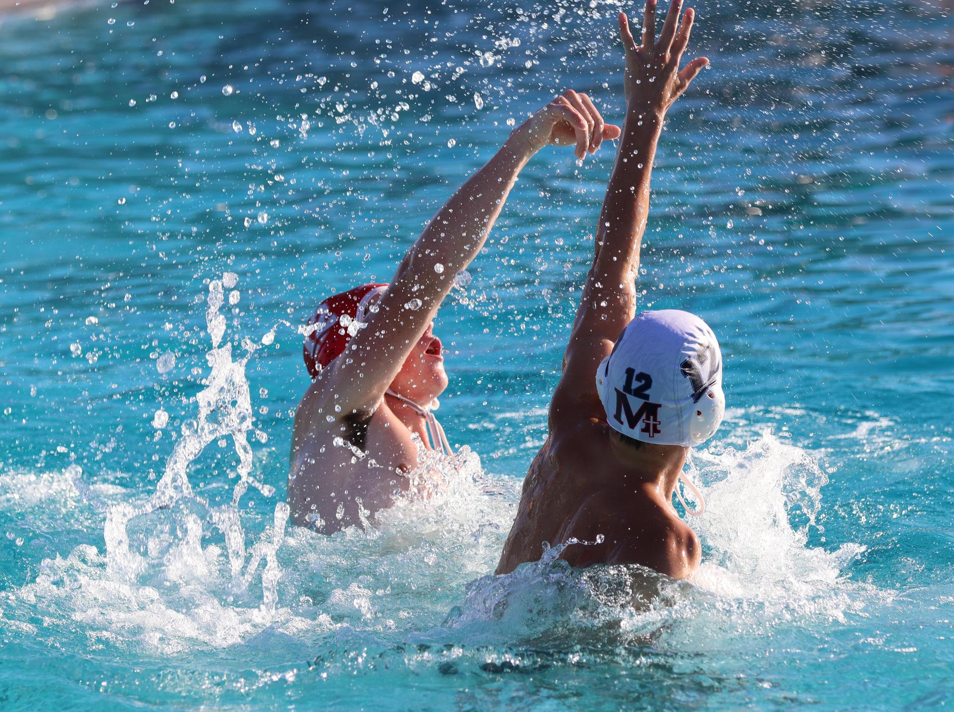 boys water polo players in action against san joaquin memorial