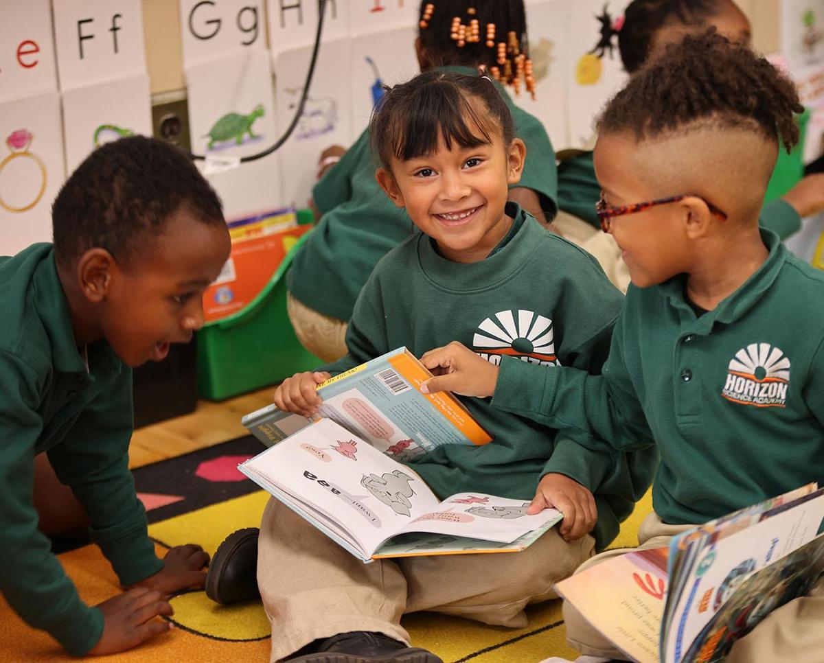 Smiling children together outdoors.