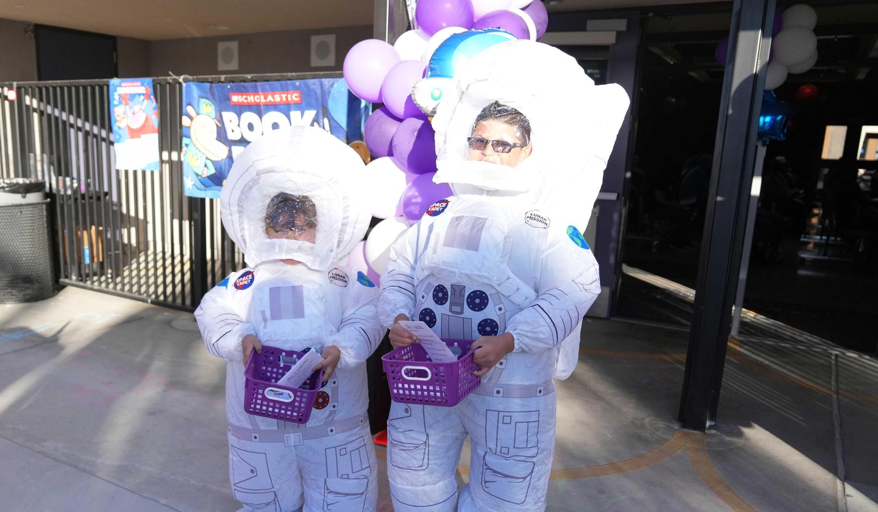 two students in inflatable astronaut costumes