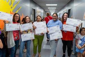Five teachers in a hallway holding Frenship Foundation Teacher Grant checks.