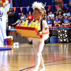 Student carrying a tray of lemonade