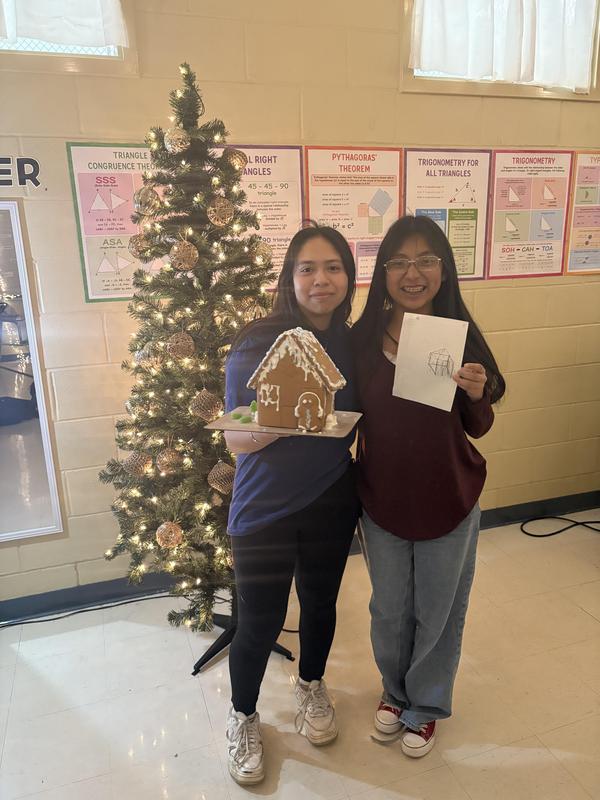 two students with their gingerbread house