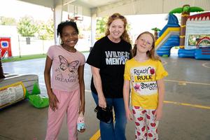 A mentor and two students enjoy the end of year celebration
