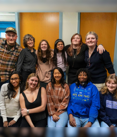 Student artists, friends, and teachers posing for group shot for their gallery