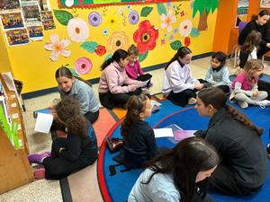 7th and kindergarten girls learning together.