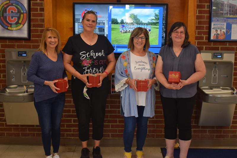 Cathy Pohlman, Monica Sottoriva, Joann Patton & Andrea Card holding a red box.