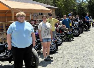PEP students stand by motorcycles outside the Mohawk Ramblers clubhouse