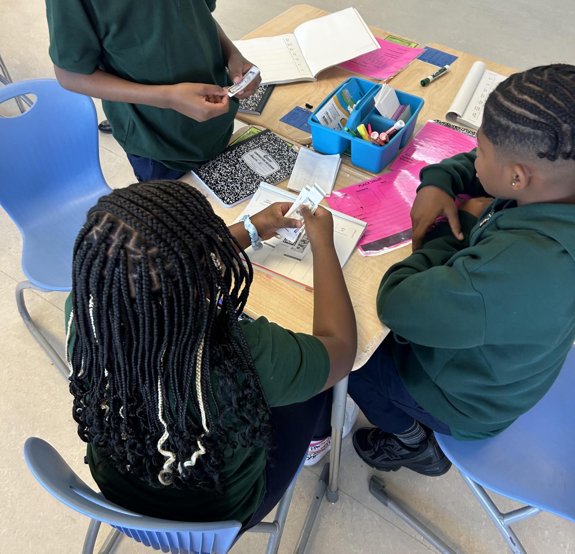 Students engaged in a collaborative learning activity at a table.
