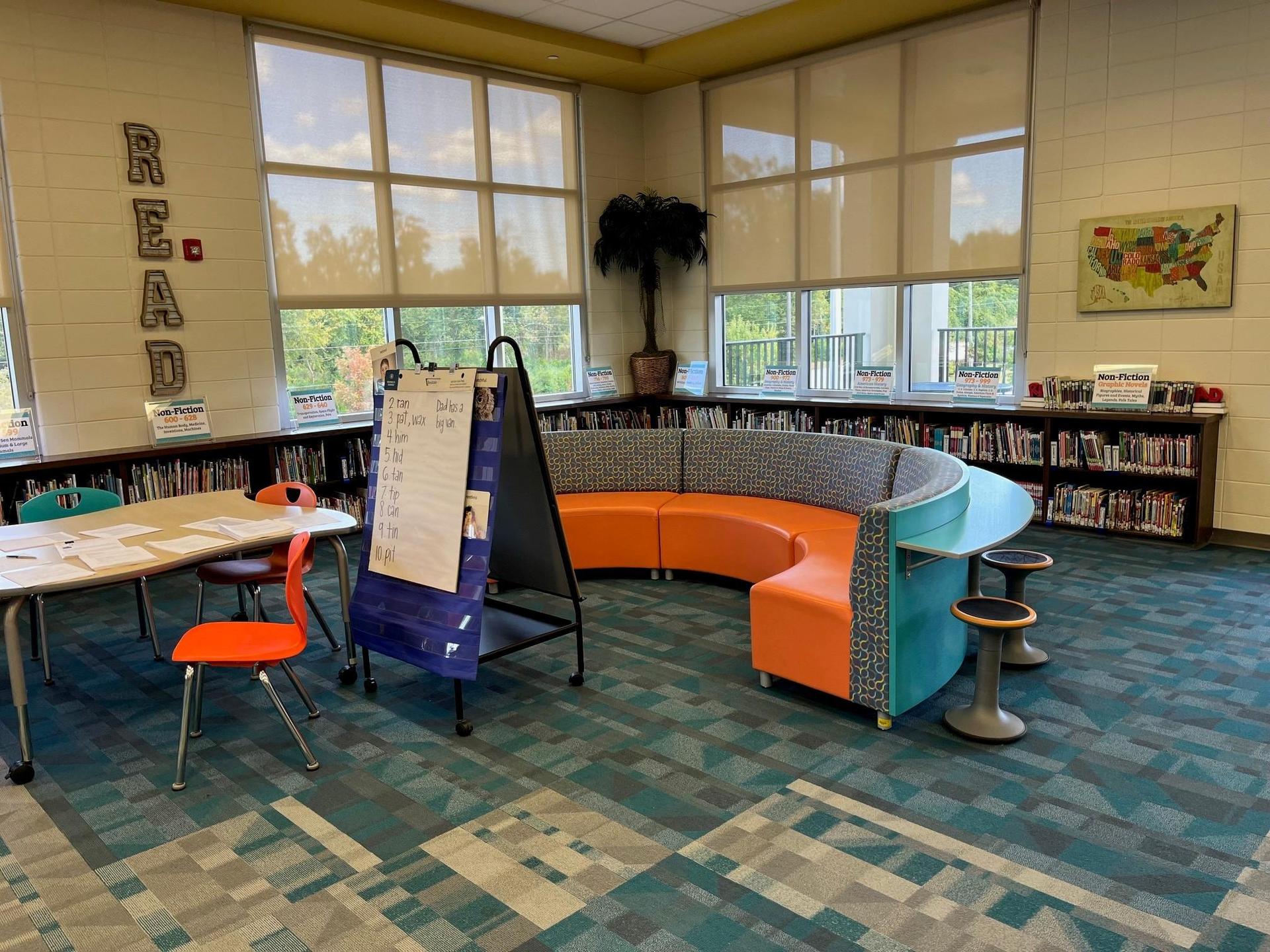 Grovetown Learning Commons space including tables, chairs, and shelves of books.