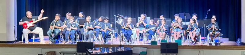 Students playing music on stage