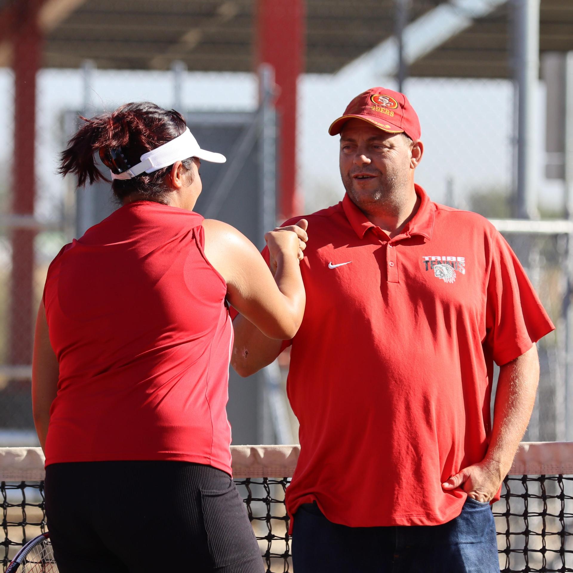 tennis players, family, and staff celebrating senior night