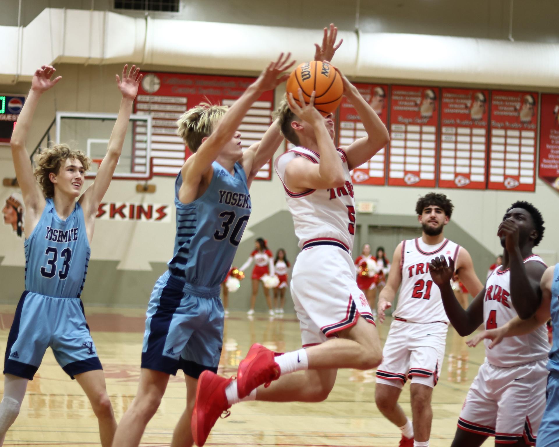 Varsity boys playing basketball against yosemite