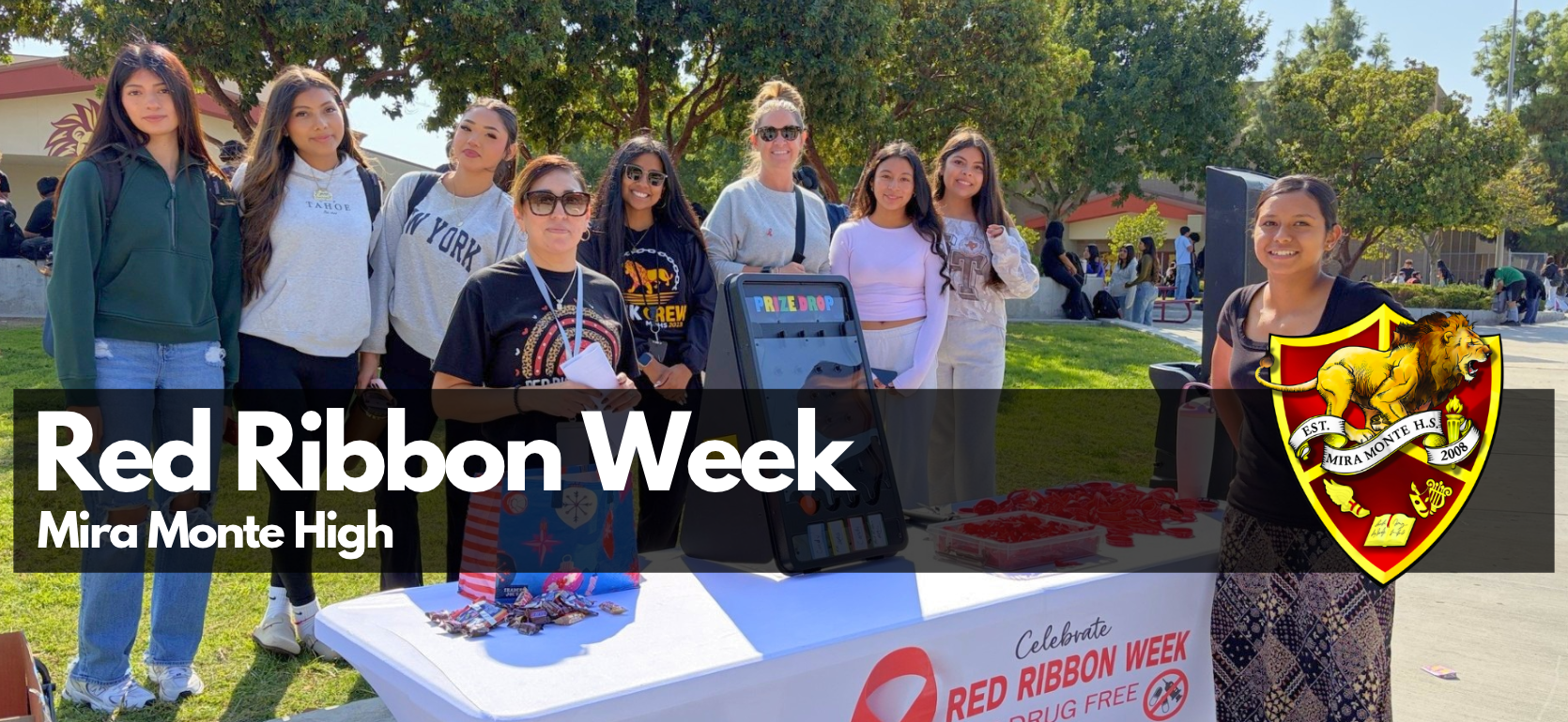 Group of students at a booth promoting Red Ribbon Week.