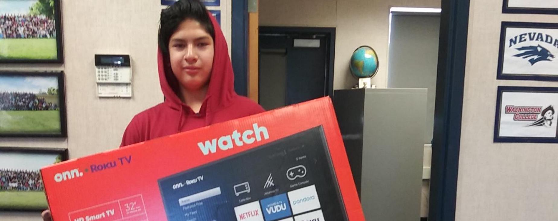Attendance raffle winner happily posing with his new tv.