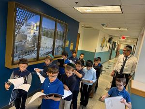 The boys daven to themselves by the kosel window at TDSA