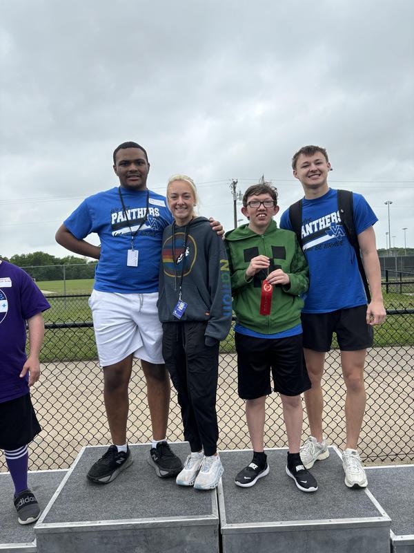 Unstoppable Athletes showing off their medals after their track meet in Anna