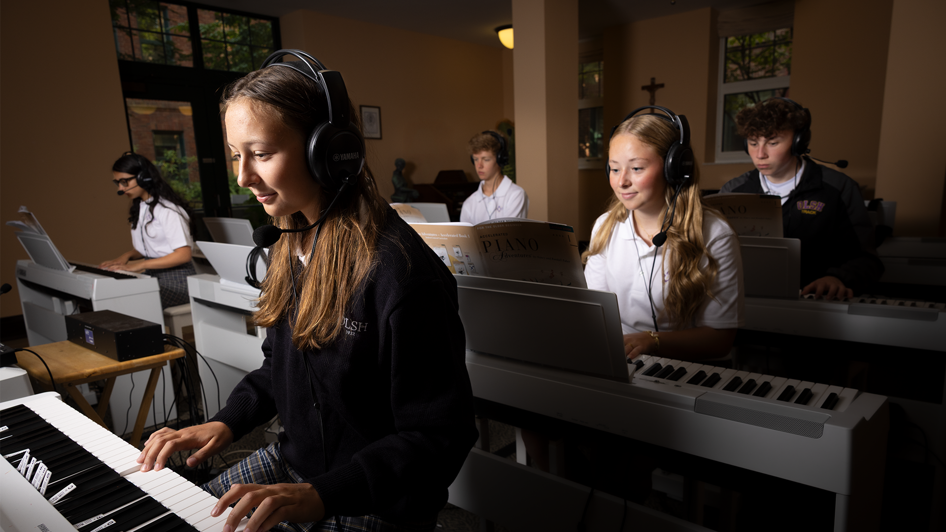 students in the OLSH piano lab