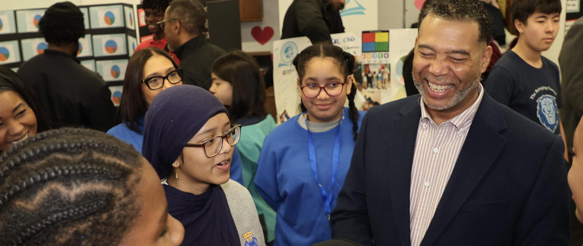 Superintendent and students smiling