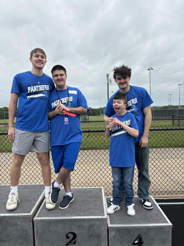 Unstoppable Athletes showing off their medals and posing with their VAHS Partners after their track meet in Anna