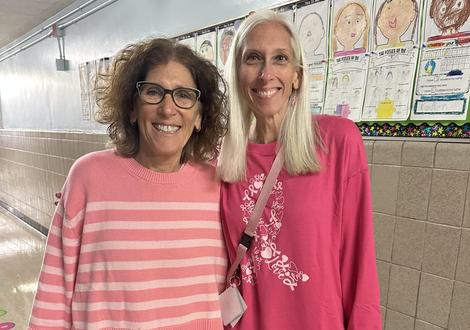 two adult females wearing pink shirts for breast cancer awareness