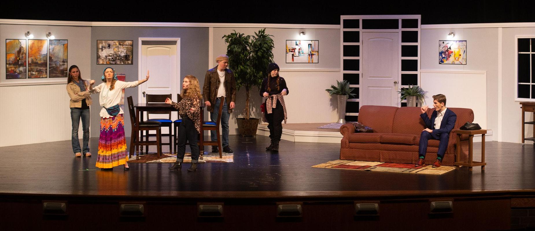 cast of six high school students acts out You Can't Beat the House play on stage