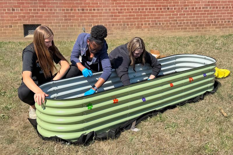 Students cultivate the school's new garden beds