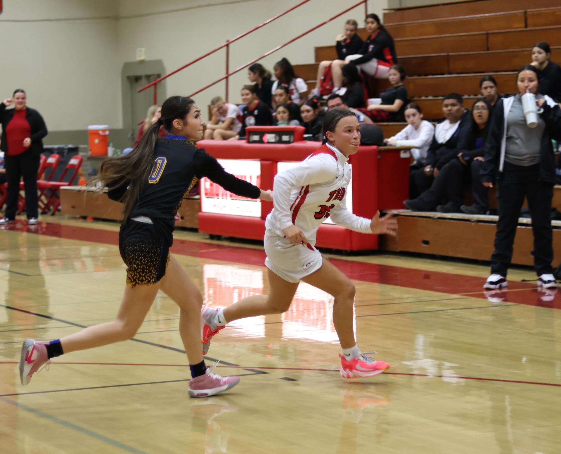 junior varsity girls playing basketball against parlier