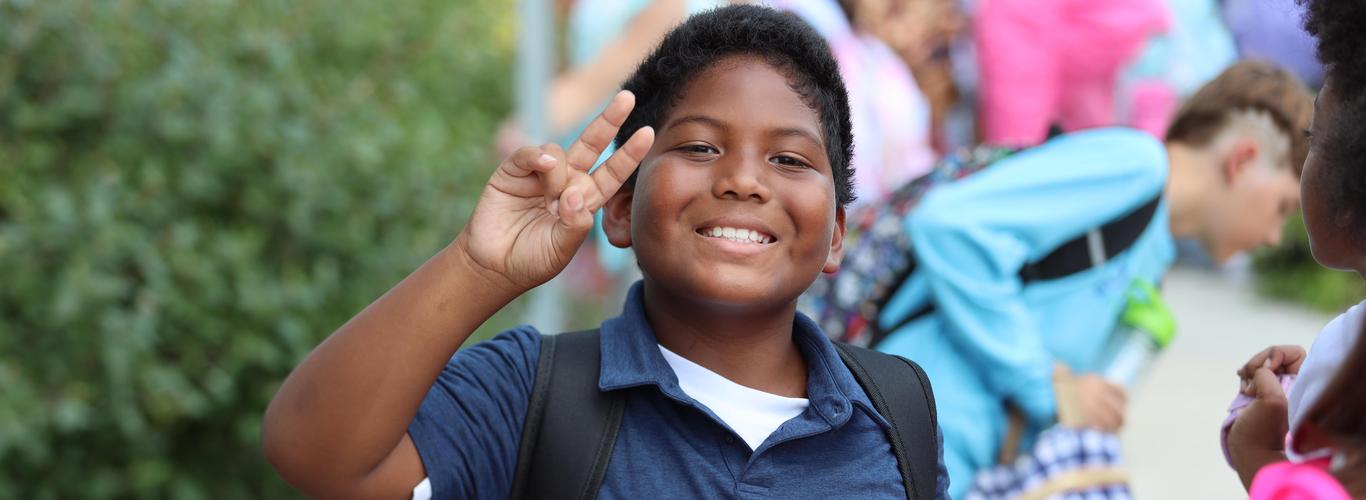 Boy waving at camera