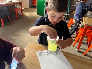 A kindergarten boy making a star projector