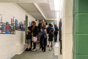 Crowd enjoying artwork on the gallery walls