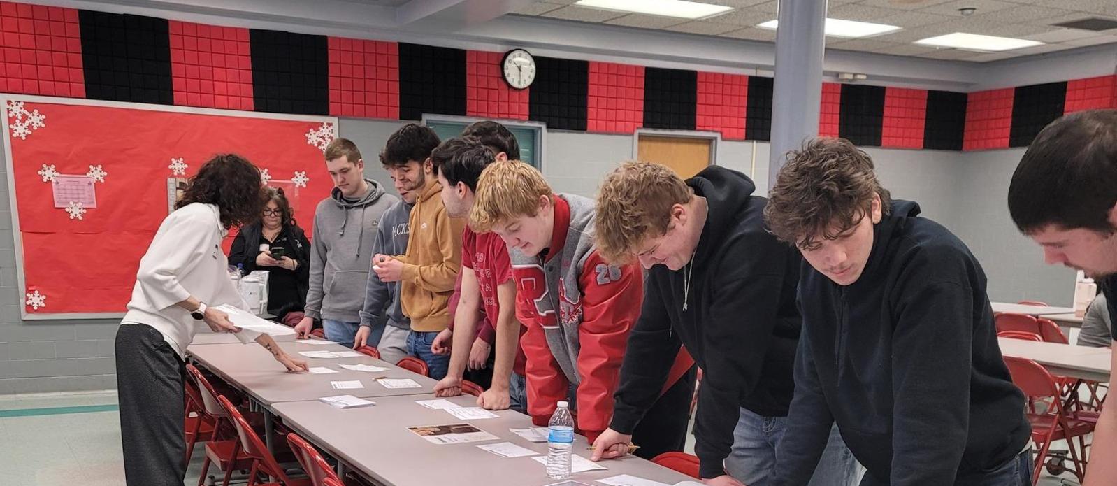 Students learning how to write a check and participating in financial lessons with In First Bank.