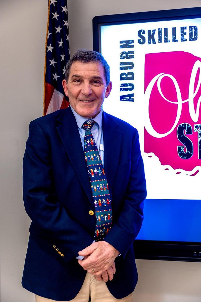 man in suit standing smiling