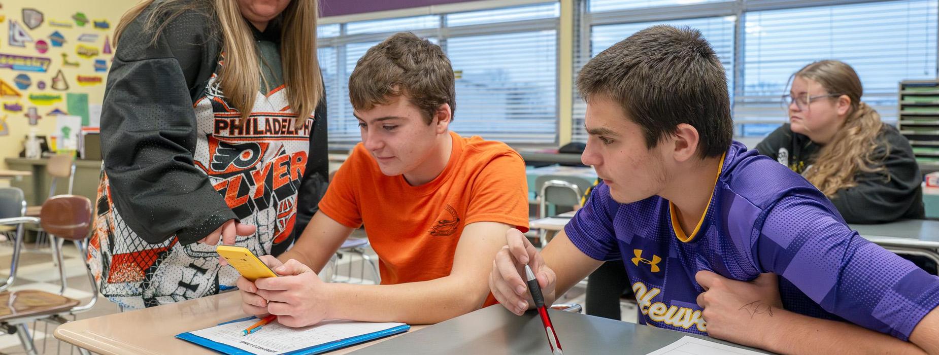 Teacher instructing students in math