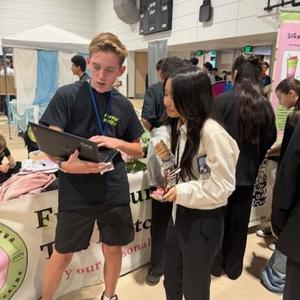 2 students looking at an ipad