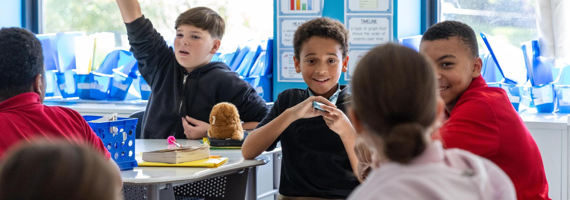 Elementary students interact in a classroom
