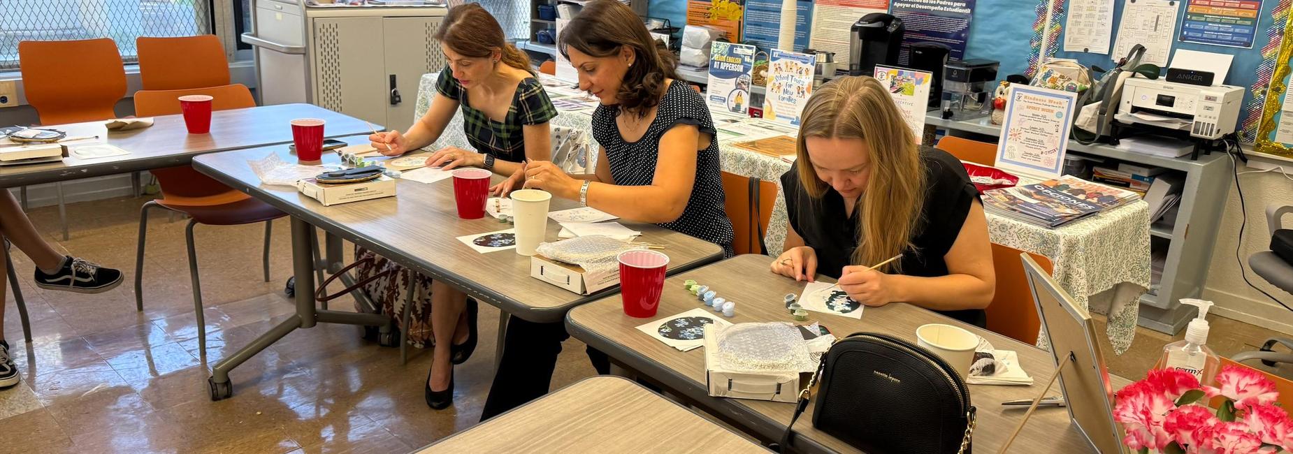 Parents enjoying a painting activity in the Apperson Parent Center