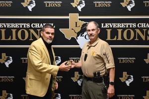 Mr. Everett presenting Guthrie with his badge.