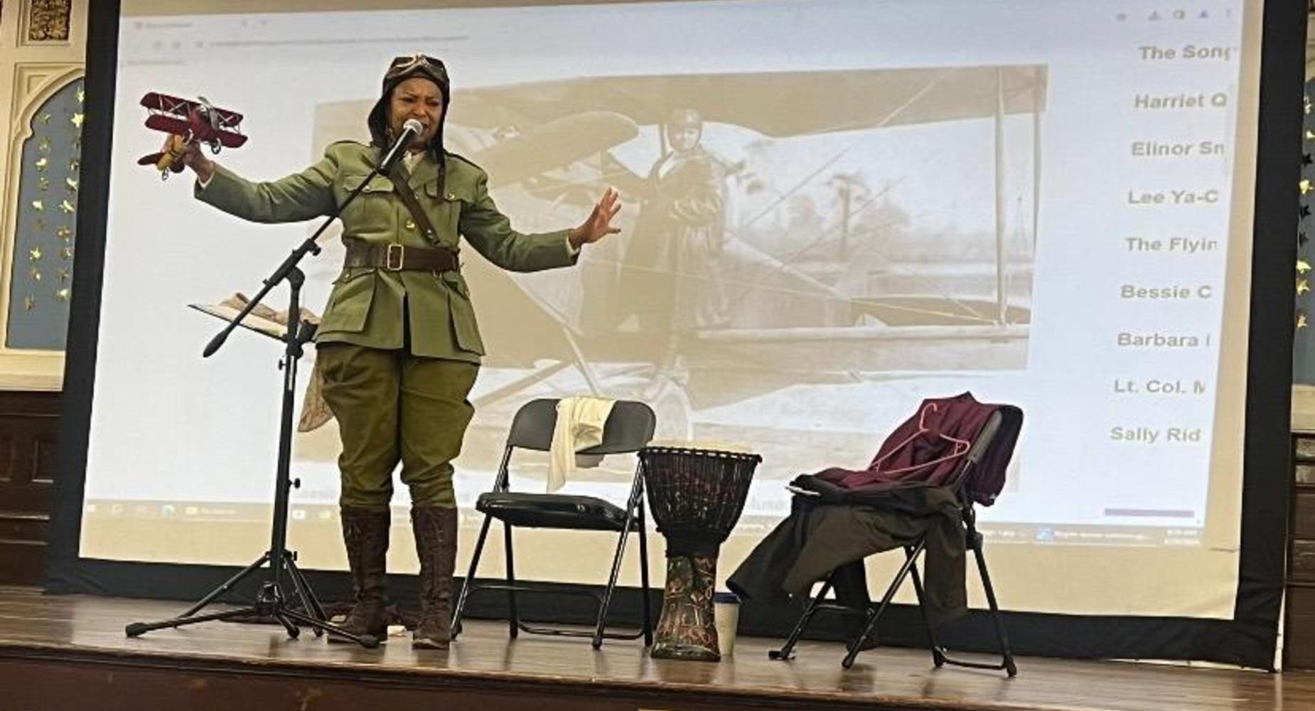 Female guest speaker dressed as Bessie Coleman for Black History Month