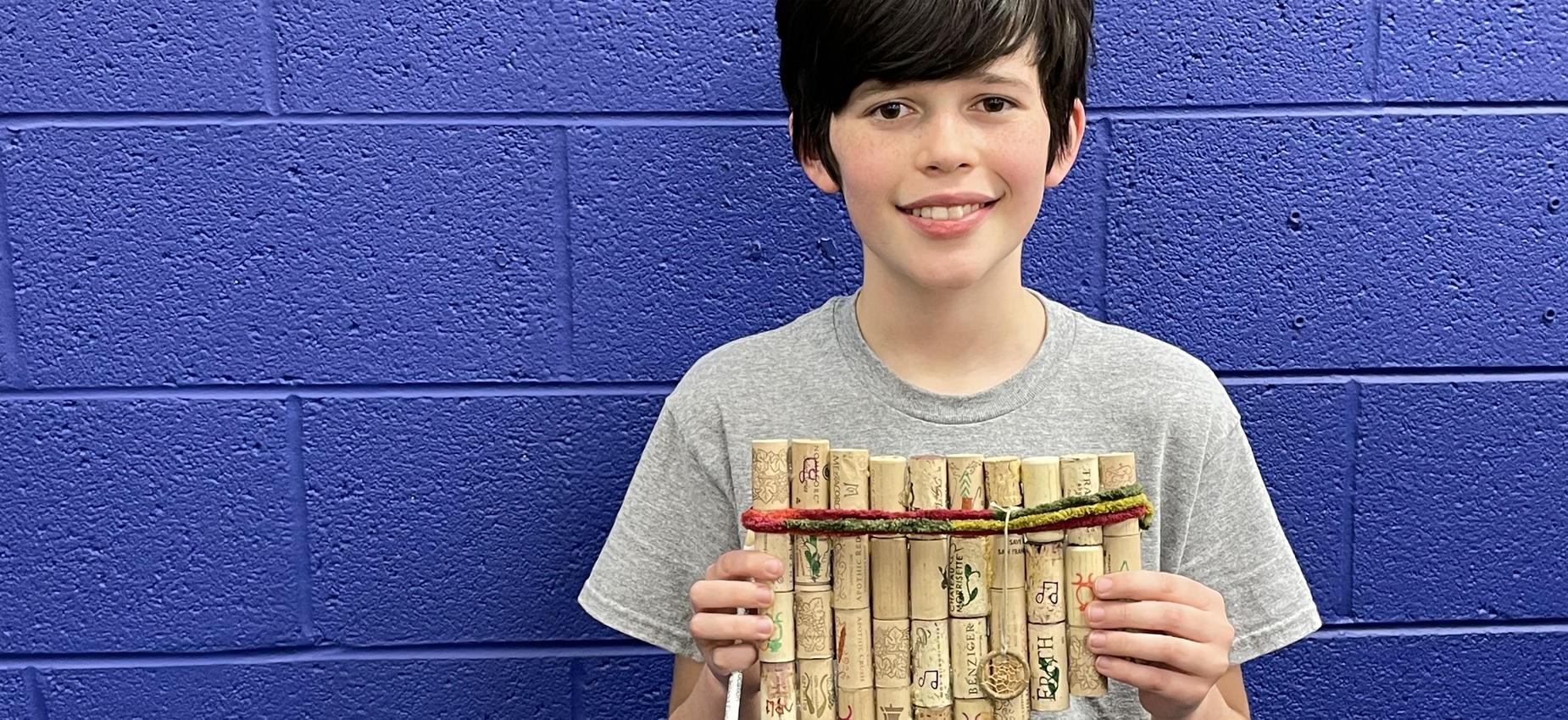 A student holds a Greek Mythology project.