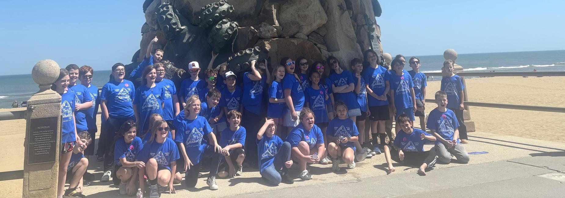 Students in front of the Triton statue at Virginia Beach